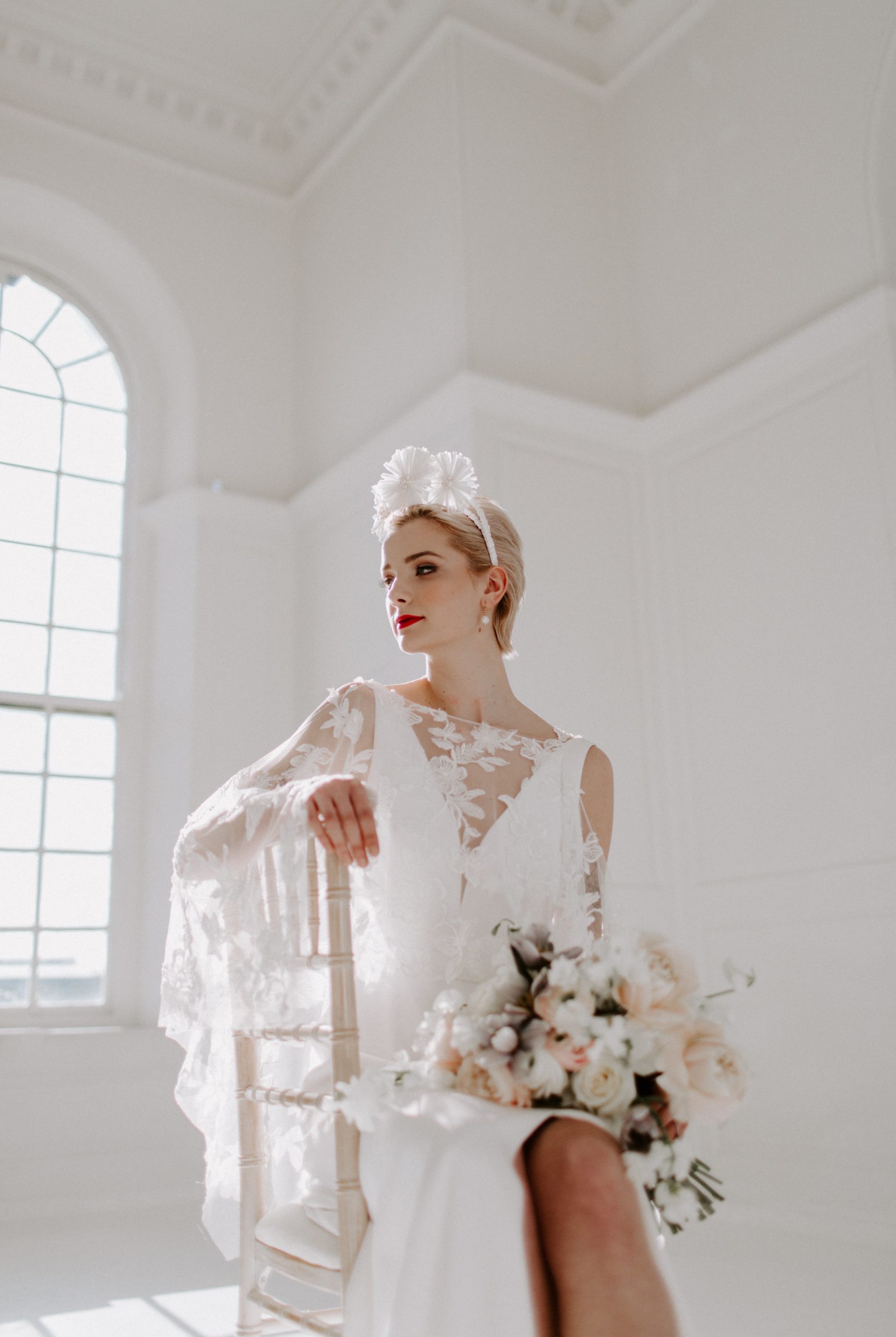 modern bride wearing wedding dress with wedding flowers